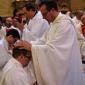 069 Fr J Bajada, Fontana Parish Priest, holds hands on Mark's head