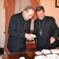 159 Bishop handing Mgr Caputo a piec of the cake